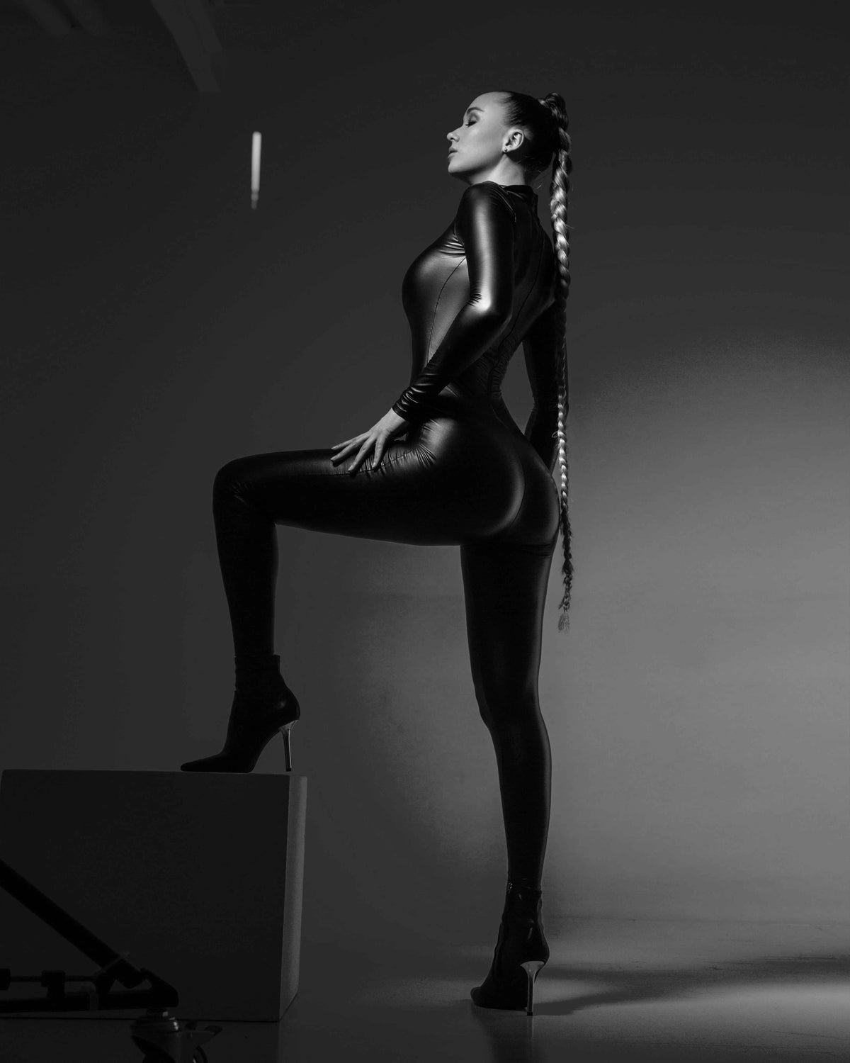 A woman wearing black leather jumpsuit