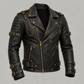 A black leather biker jacket with bronze hardware, featuring a snap collar, asymmetrical zipper, chain detail, and multiple buckle straps on the sleeves and waist, shown against a solid gray background.