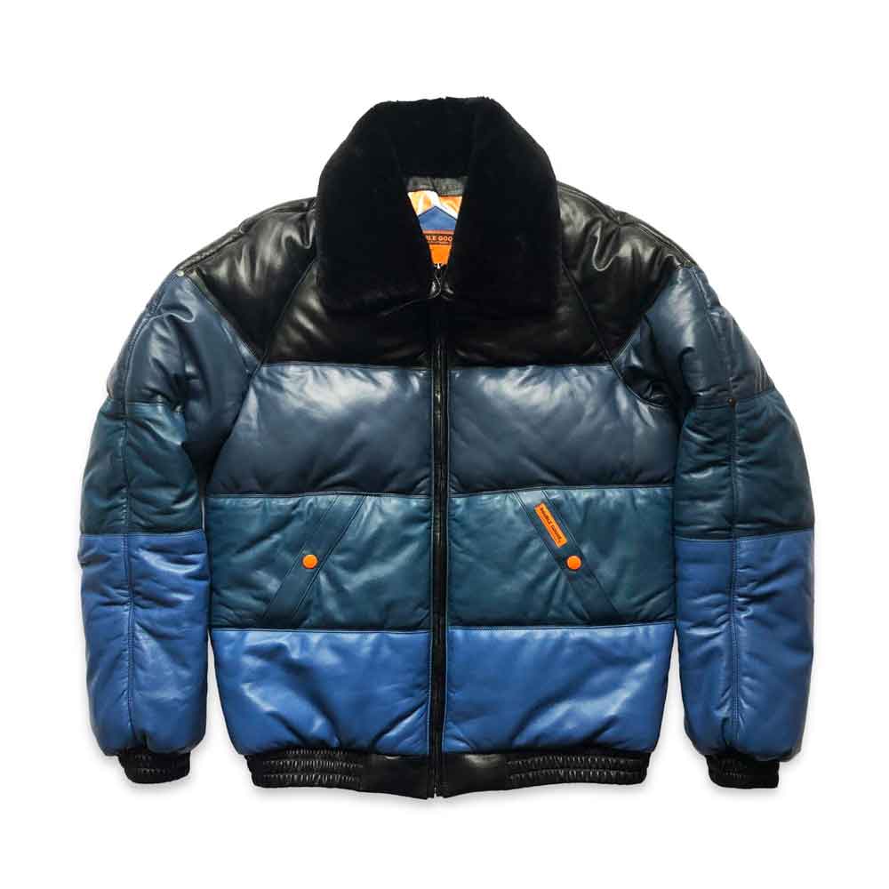 A color-blocked v bombeer jacket with a black leather upper chest and collar, a dark teal middle section, and a medium blue lower section, featuring a black fuzzy collar and black ribbed trim.