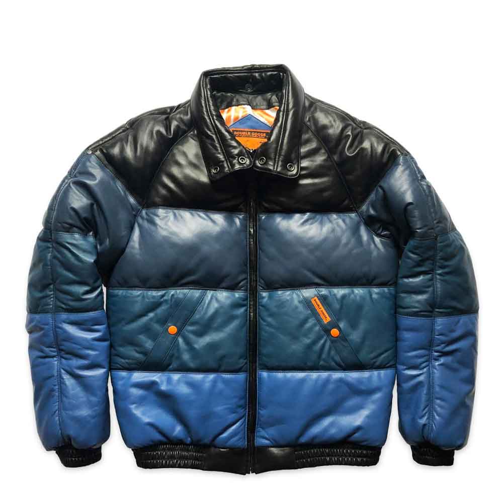 A color-blocked v bomber jacket with a black leather-look collar and shoulders, dark blue middle body panels, and bright blue lower body and sleeves, featuring orange accents and a front zipper.