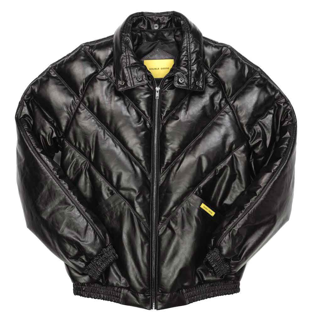 A black quilted bomber jacket with a front zipper, ribbed collar, cuffs, and hem, featuring small yellow brand tags on the chest and inside the collar.