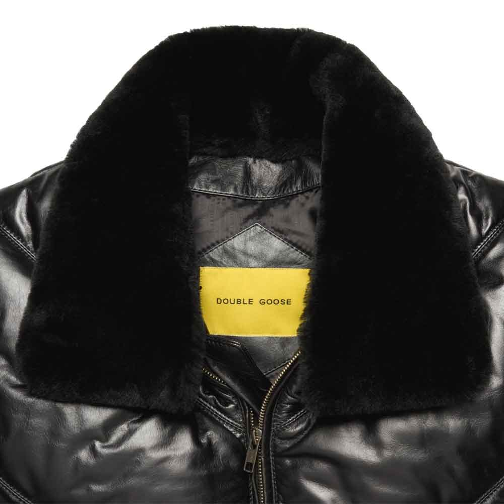 Close-up of a black leather jacket with a thick black fur collar and a yellow label reading 'DOUBLE GOOSE' inside the neck.