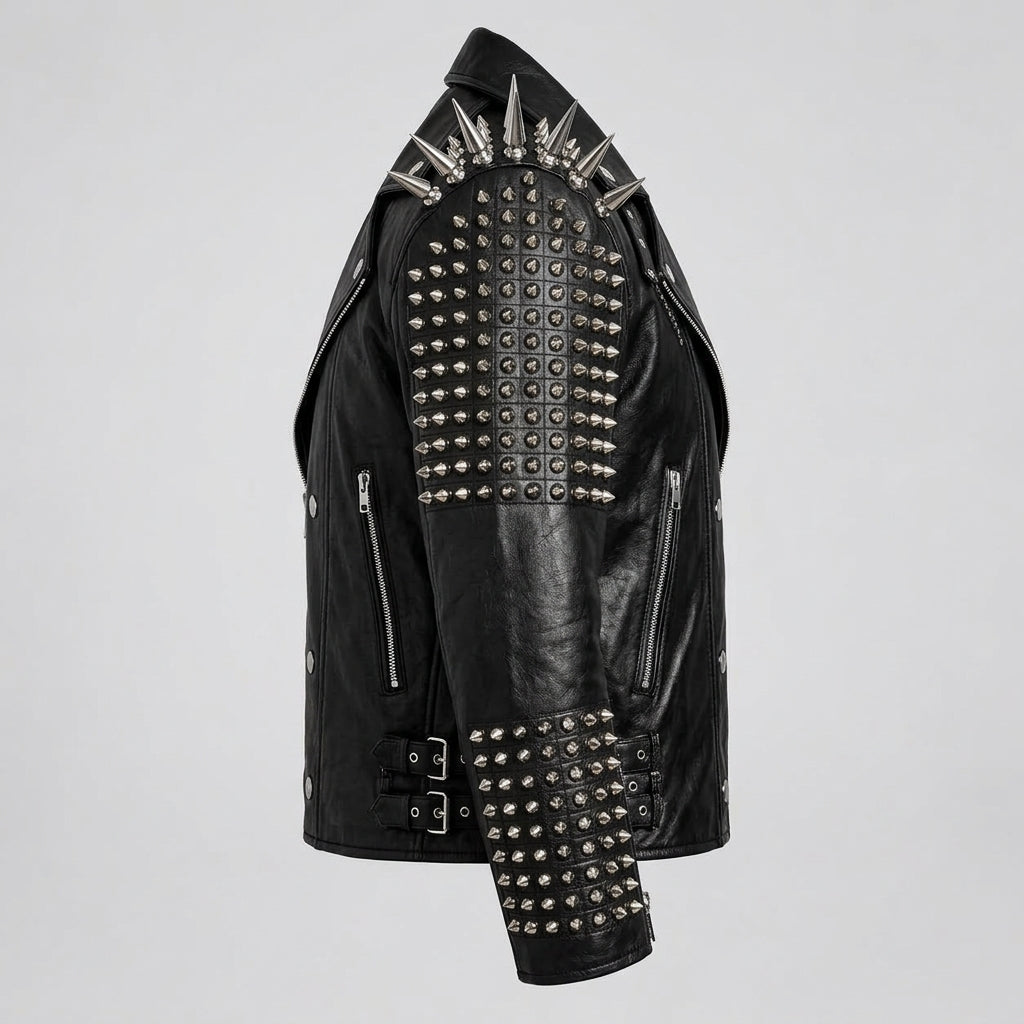 Black leather motorcycle jacket heavily embellished with silver metal spikes and studs, shown from a three-quarters angle on a light gray background.