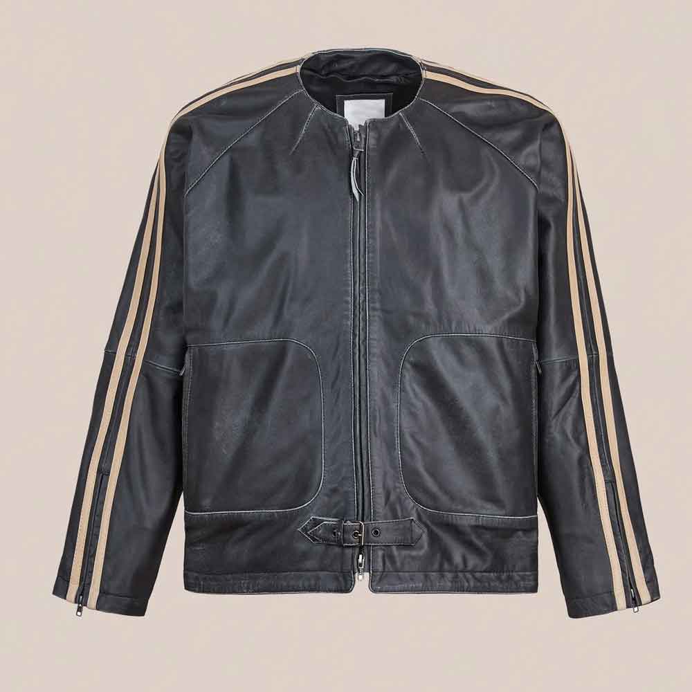 A vintage track jacket with beige stripes down the sleeves, displayed flat against a solid beige background.