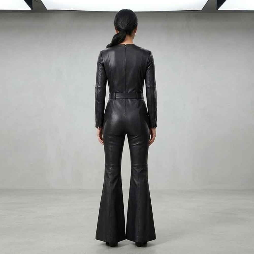 A model viewed from the back wearing a Bell Bottom Jumpsuit with long sleeves, a defined waist, and flared legs, set against a minimalist gray studio background.