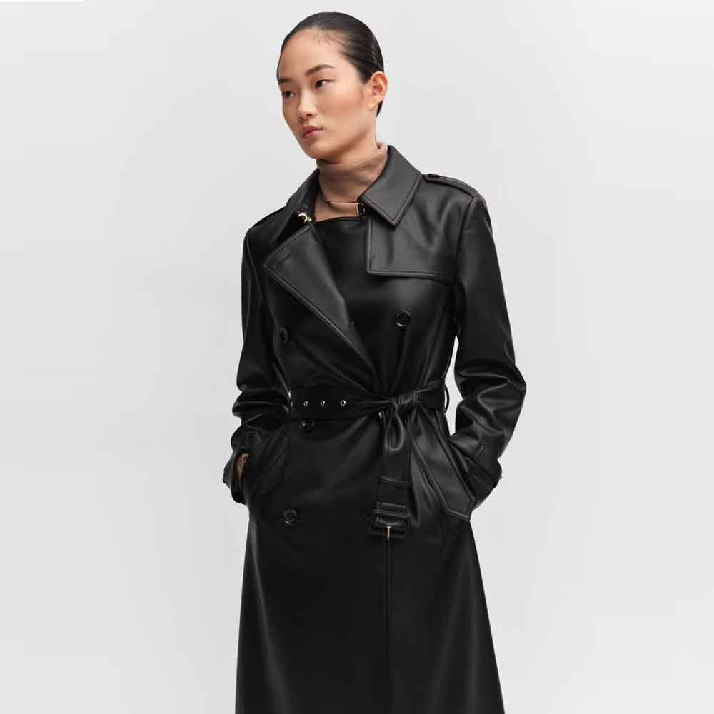 A women wearing a black leather trench coat