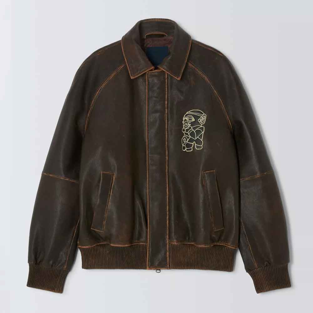 A Embroidered Bomber Jacket with a distressed finish, featuring a light beige embroidered graphic on the left chest and contrast stitching, shown against a light gray background.