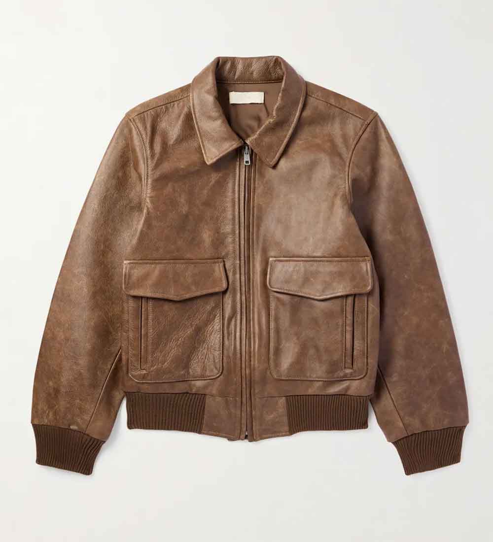 A Los Angeles Bomber Jacket with a distressed finish, featuring a front zipper, two large flap pockets, and ribbed knit cuffs and hem, laid flat against a light off-white background.