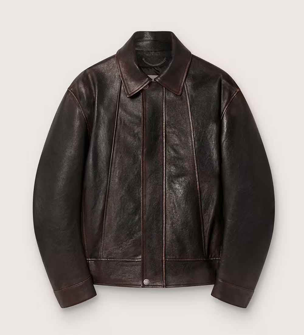 A Mens Brown Leather Bomber Jacket with a pointed collar, button front, and visible contrast stitching, photographed flat against a light gray background.