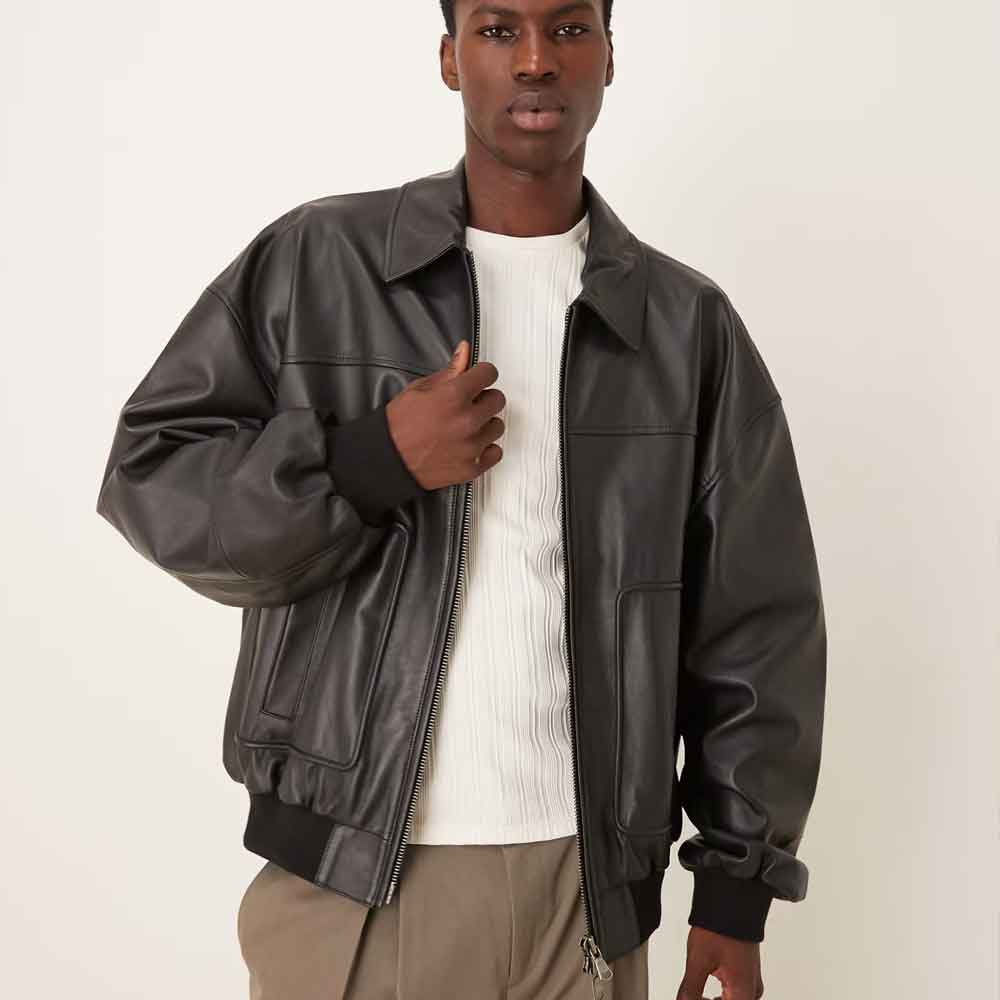 a model wearing an Oversized Leather Bomber Jacket against a light background