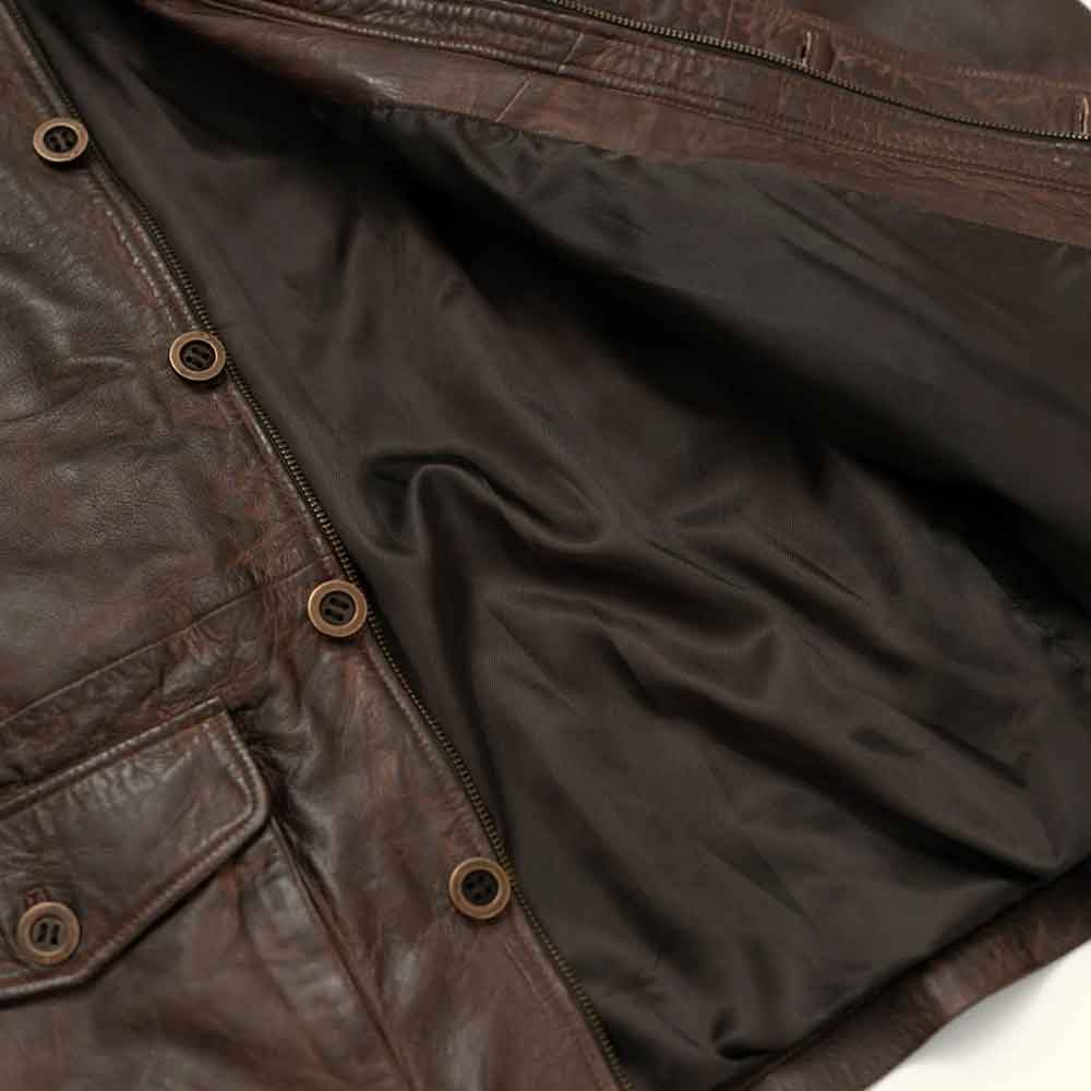 Close-up of a dark brown leather jacket showing the interior lining, zipper, and metal snap buttons.