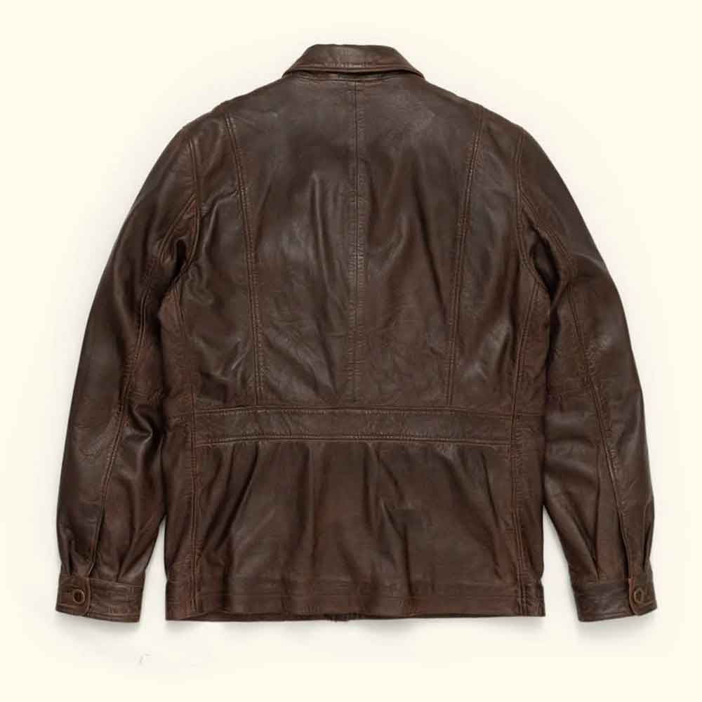 A dark brown Vintage Barn Jacket shown from the back, featuring a collar, long sleeves, and a stitched waist seam, laid flat against a light cream background.