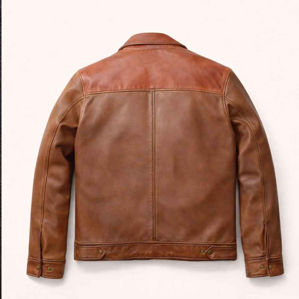 A brown leather jacket shown from the back, featuring a smooth back panel and contrasting slightly lighter brown shoulder yoke, photographed against a clean off-white background.
