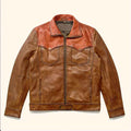 A brown leather jacket with a contrasting reddish-brown collar and yoke, featuring a front zipper, two chest flap pockets, and side slip pockets, laid flat against a light cream background.