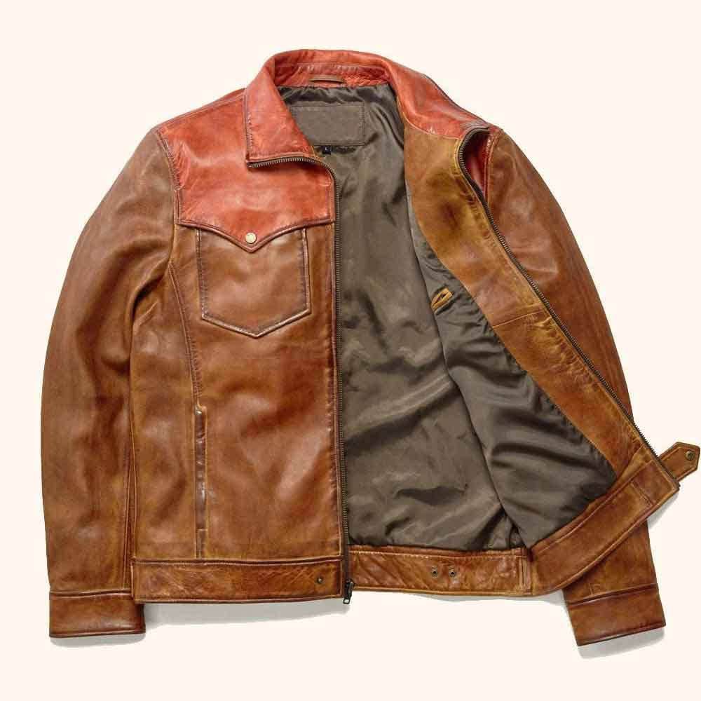 A brown leather jacket with a warm reddish-brown collar and shoulder panels, shown open against a light cream background.
