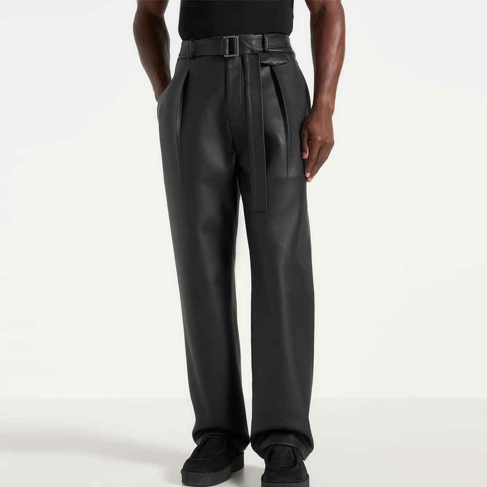 a man wearing wide leg leather pants against a gray background